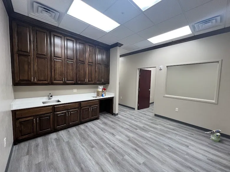 Dark stained office cabinets and doors in a commercial space