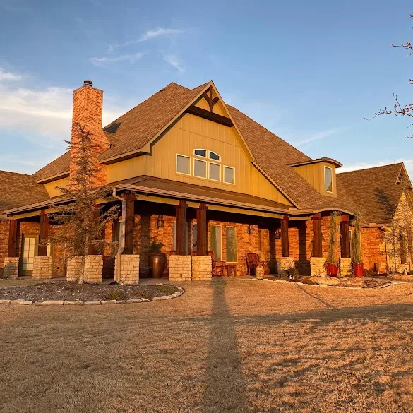 Brick ranch home with painted gables and stained porch columns